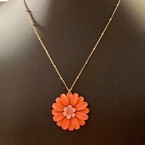 Beautiful Orange Flower Necklace on a delicate looking gold toned chain.